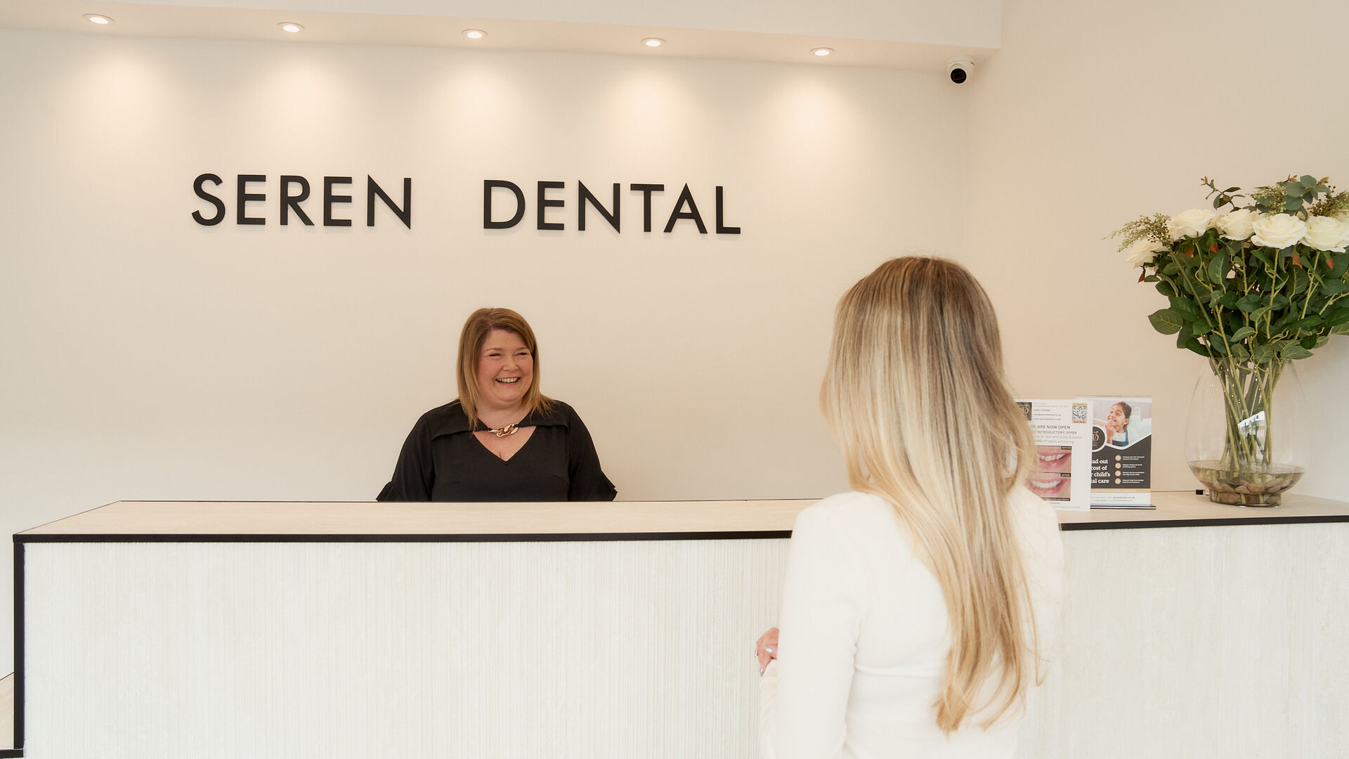 Receptionist welcoming a patient at the Seren Dental front desk, a private dentist in Penylan, Cardiff
